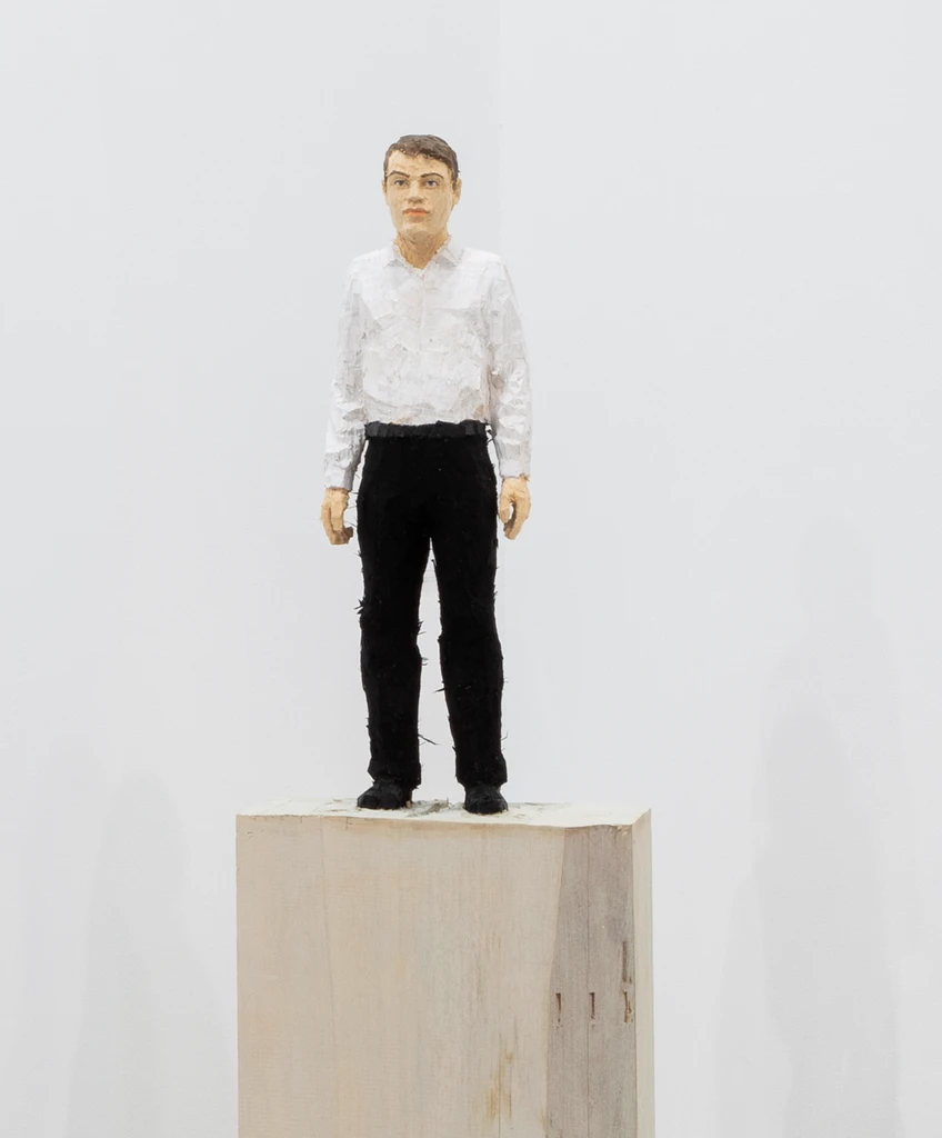 Man with black trousers and white shirt